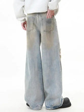 Men’s full size distressed wide leg jeans in faded light blue denim with subtle distressing and raw hem