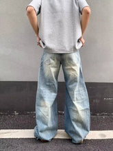 Men’s full size distressed wide-leg jeans in faded light blue denim with subtle distressing details