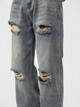 Men’s full size distressed wide leg jeans in gray denim with frayed ripped knee holes and faded wash plus size