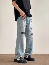 Men’s full size light blue distressed wide leg denim jeans with subtle pattern and ripped details
