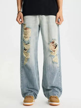 Men’s light-wash denim full size distressed wide leg jeans with frayed holes on the thighs in plus size