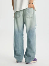 Men’s light-wash denim full size distressed wide leg jeans with subtle distressing details and plus size fit