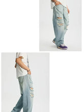 Men’s full size distressed wide leg light-wash denim jeans with ripped details on thighs and knees
