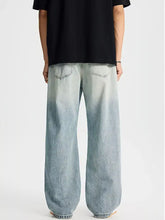 Men’s full size distressed wide leg jeans in light-wash denim with a relaxed fit and wide leg design