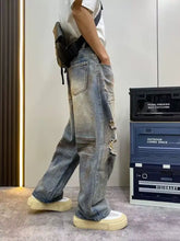 Men’s full size distressed wide light-wash denim jeans with ripped details and a relaxed wide leg cut