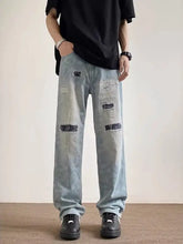 Men’s full size distressed wide leg jeans in light-wash denim with ripped patches and a faded textured appearance
