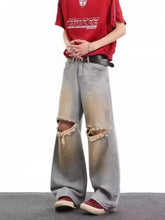 Men’s light-wash denim wide leg jeans with distressed ripped knees and frayed edges in full size plus format