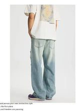 Men’s full size light-wash denim jeans with a relaxed wide-leg cut and subtle distressing along the sides
