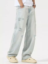 Men’s light-wash denim wide leg jeans with distressed ripped details on thighs and knees plus size full size