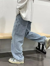 Men’s light-wash size distressed wide leg jeans with a relaxed straight-leg cut and subtle knee distressing