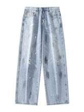 Men’s plus size wide-leg jeans in light distressed wash with paint-splatter design and rips at the knees