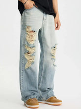 Men’s light-wash denim distressed wide leg jeans with frayed tear details on the outer thigh in plus size
