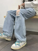 Men’s light-wash size distressed wide jeans with ripped knees and frayed edges in a full plus size wide leg fit
