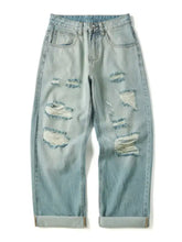 Men’s light-wash denim full size distressed wide leg jeans with multiple rips, frayed edges, relaxed fit, and rolled cuffs