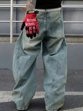 Men’s full size distressed wide leg jeans in light-wash denim with relaxed fit and visible stitching details