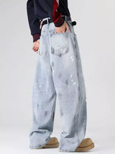 Men’s plus size light-wash distressed wide-leg jeans with paint splatter and ripped back pocket showing the back side