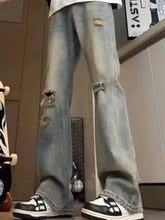 Men’s full size light-wash denim distressed wide leg jeans with ripped knees and frayed edges