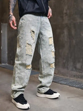 Men’s full size distressed wide leg light-wash denim jeans with ripped patches, yellow stitching, and faded floral embroidery perfect fit