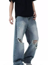 Men’s full size distressed wide leg light-wash denim jeans with ripped knees and frayed edges