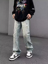 Men’s full size light-wash denim wide-leg jeans with distressed patches and geometric stitching details