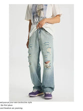 Men’s full size distressed wide leg light-wash denim jeans with ripped details on thighs and knees