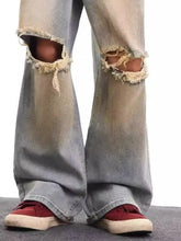 Men’s full size distressed wide leg light-wash denim jeans with frayed knee holes and a faded worn-in look