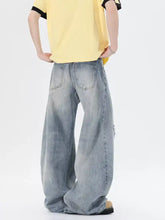 Men’s full size light-wash denim distressed wide leg jeans with a relaxed fit and subtle distressing details