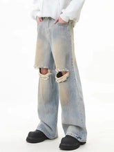 Men’s full size distressed light-wash denim wide leg jeans with frayed knee holes and a faded worn appearance