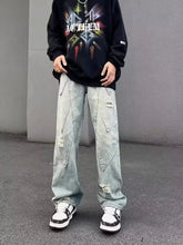 Men’s full size distressed wide leg jeans in light-wash denim with reinforced stitching and patch details