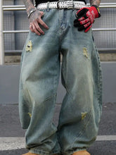 Men’s full size distressed wide leg jeans in light-wash denim with rips, faded patches, and a studded belt