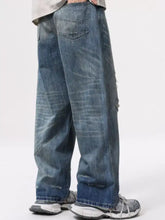 Men’s full size distressed wide leg jeans in medium-wash blue denim with frayed details and subtle fading