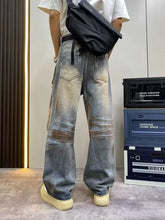 Men’s full size distressed wide leg jeans in washed denim with faded patches and a relaxed wide leg cut