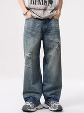 Men’s full size distressed blue denim wide leg jeans with ripped knee patches and a relaxed fit design