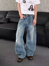 Men’s full size distressed wide leg jeans in light-wash denim with ripped details and a relaxed wide leg cut