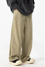 Loose-fitting light brown cargo pants with drawstring waist, plus size pockets