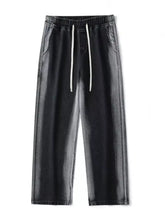 Men’s black denim joggers with white drawstrings featuring a relaxed fit plus size wide leg design