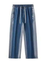 Men’s plus size blue denim joggers with relaxed fit wide leg and white drawstring in a faded two-tone wash