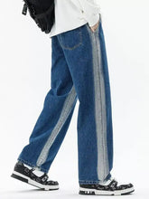Men’s blue denim plus size wide leg jeans with relaxed fit and light gray vertical stripes down outer leg