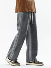 Men’s dark gray denim wide leg jeans with a relaxed fit plus size and white drawstring waist detail