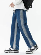 Men’s blue denim wide leg jeans with faded vertical stripes featuring a relaxed fit and plus size drawstring waist