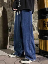 Men’s plus size dark blue denim wide leg jeans with drawstring and visible stitching along the seams