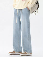 Men’s light-wash denim full size drawstring wide leg jeans with relaxed straight-leg cut and white drawstrings