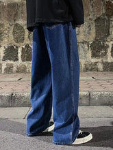 Men’s plus size dark blue wide leg jeans with a relaxed fit and visible stitching in full size drawstring style