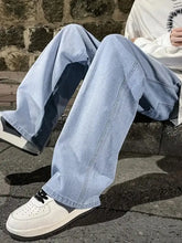 Men’s plus size wide leg jeans in light-wash denim with dark blue contrast panels along outer leg seams