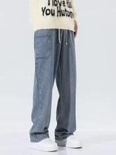 Men’s light-wash denim drawstring wide leg jeans with relaxed fit and white waistband plus size full size