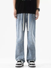 Men’s plus size wide leg jeans in light-wash denim with a relaxed straight-leg cut and white drawstring waistband