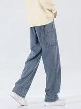 Men’s light-wash denim drawstring wide leg jeans with a relaxed fit and cargo-style pockets in full size plus size