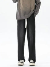 Men’s full size black wide-leg trousers with white drawstring and loose fit for comfort and style