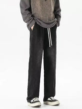 Men’s full size gradient wash loose fit jeans in black corduroy with tapered leg drawstring waistband and vertical stitching