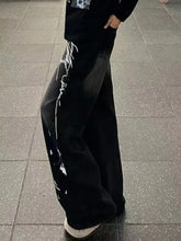 Men’s black wide-leg denim pants with bold white graffiti print wide graphic down the side in plus size